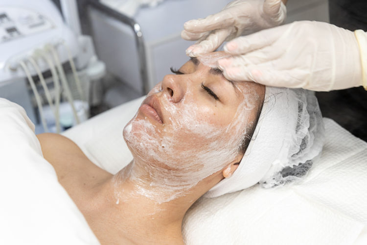 A woman getting a facial by Skincare by Anna.
