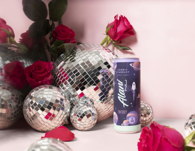 Alani Nu Canned energy drink in a fun creative photography set featuring pink disco balls and roses
