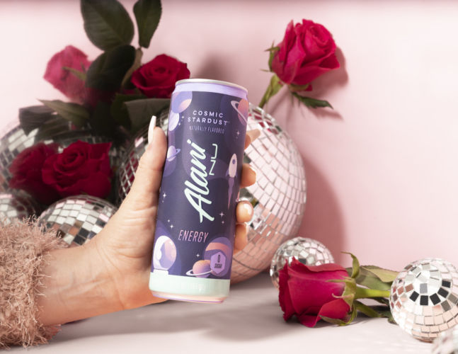 Alani Nu Canned energy drink in a fun creative photography set featuring pink disco balls and roses