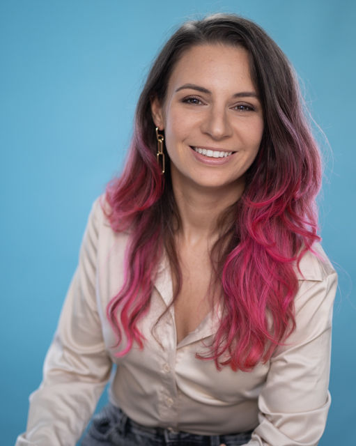 Christina Russo smiling at the camera wearing a cream colored blouse.