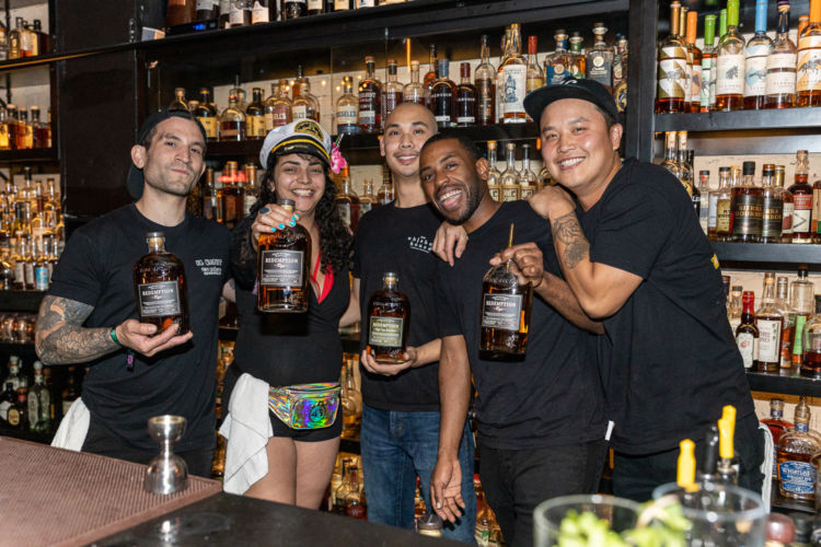 A group of bartenders posing for the Redemption Whiskey at Bartender’s Weekend