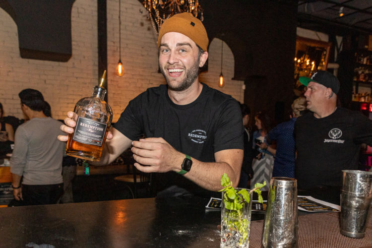 A guest enjoys Redemption Whiskey at Bartender’s Weekend