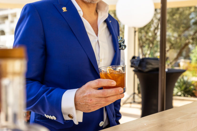 A man holding a glass with the Macallan noble oak.