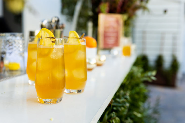 Lemony drinks on a white bar top.