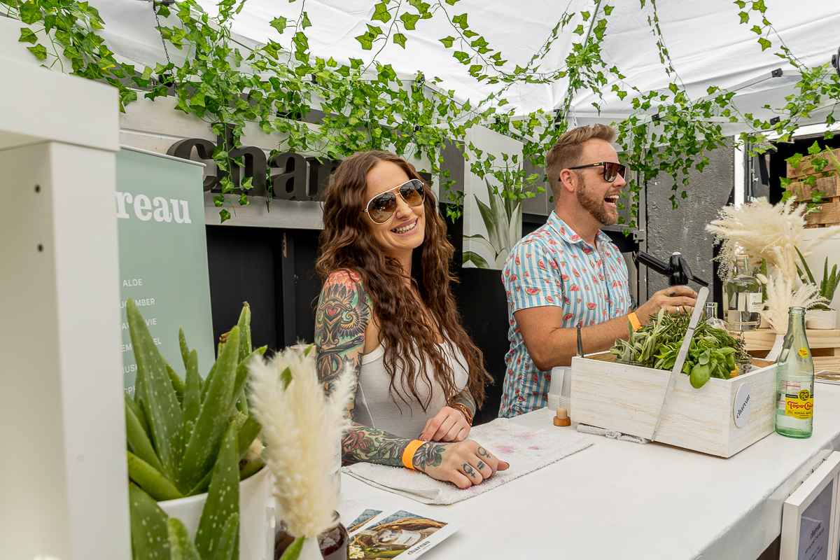A woman smiling at the camera during the Art Beyond the Glass 2022.