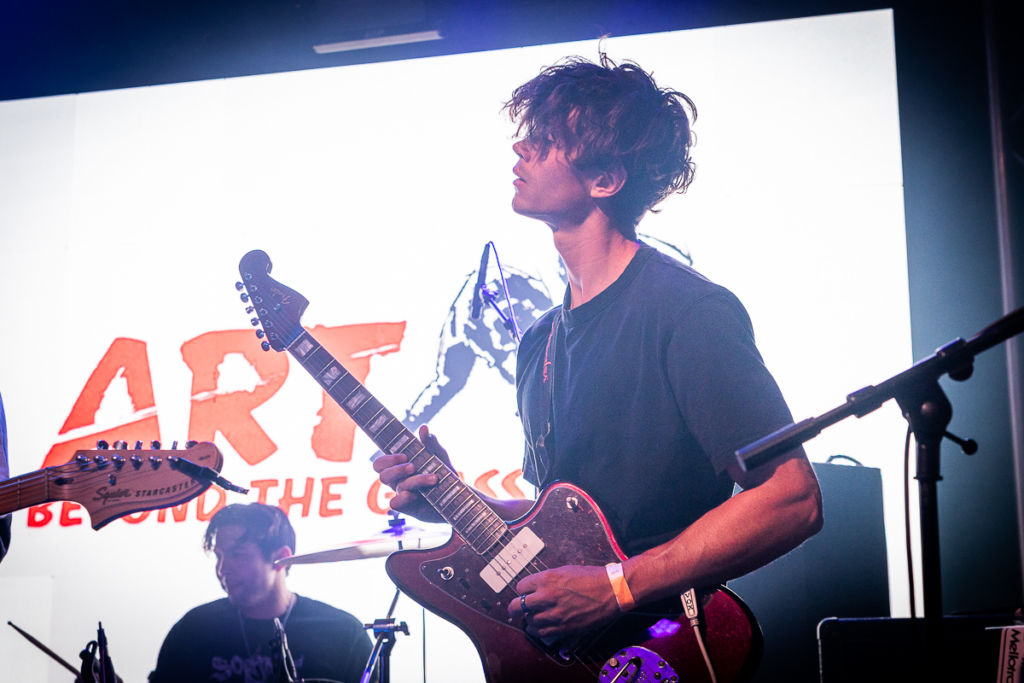 A guitarist playing during the Art Beyond the Glass 2022.