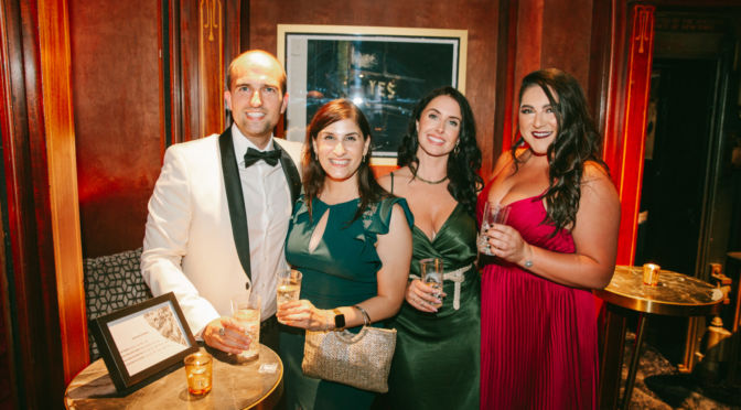 Guests of the event smiling at the camera.