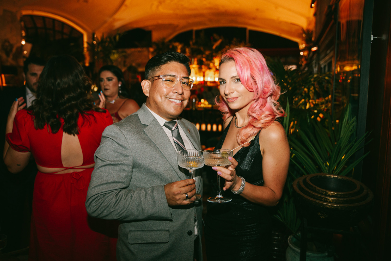 A man wearing a tux and a woman wearing a black dress holding their glasses during the Beam Suntory Casino Night.