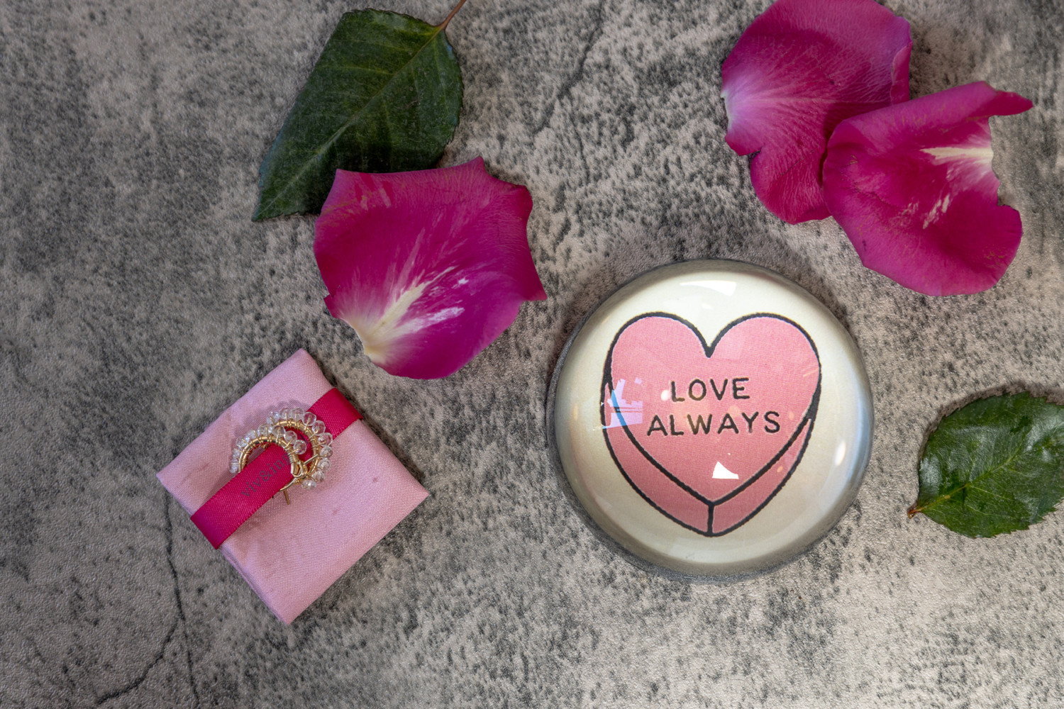A Love Always dome with rose petals and leaves.
