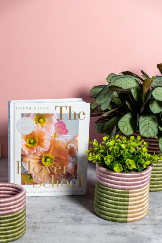 The Flower School book photographed with different plants.
