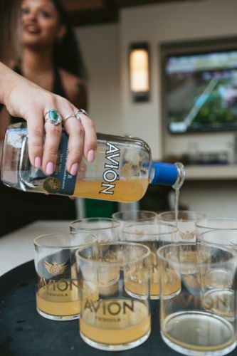 The Avion being poured on glasses on a tray.
