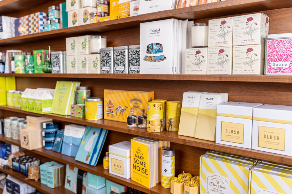 Boxes and products lined up in a wooden shelf.