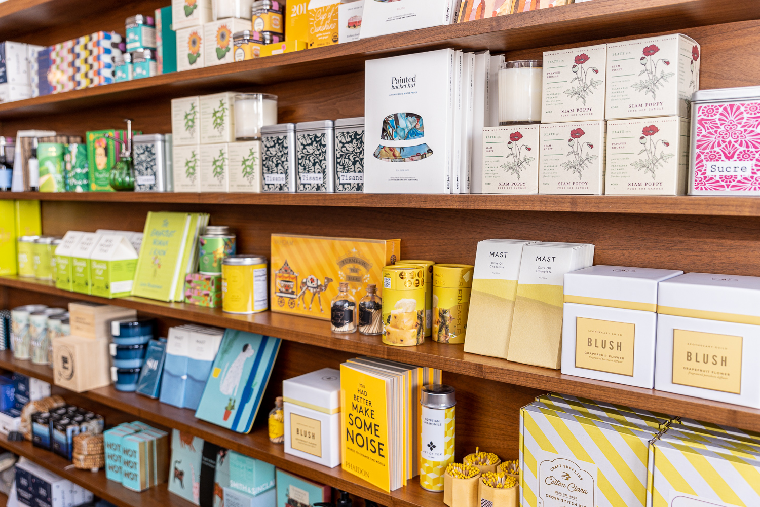 Boxes and products lined up in a wooden shelf.