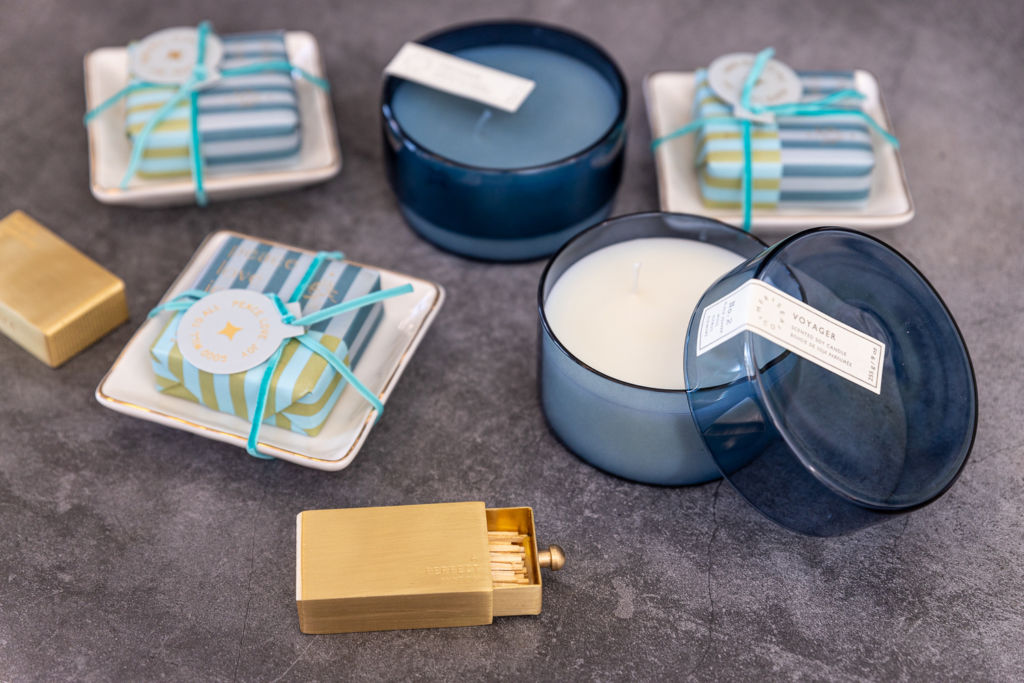 Open matches, and candles in a blue container with gift-wrapped boxes.
